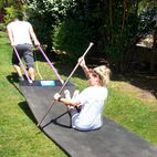 Algarve hot tub personel having fun with mimicking kajacking ona ruber mat.